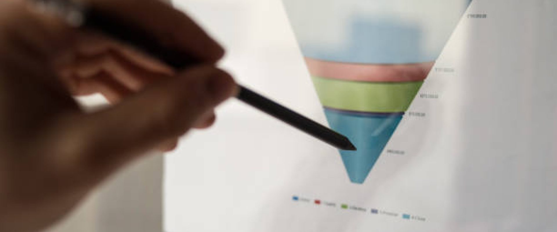 Male hand pointing with a pencil at a sales funnel chart or sales pipeline during a business meeting in office. Concept of marketing strategy